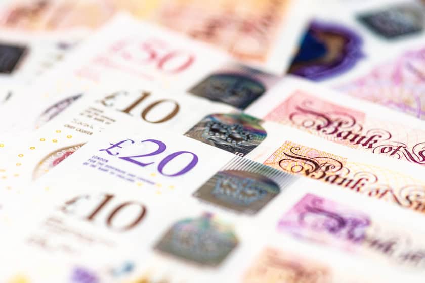 Bank of England notes in a row stacked on top of one another