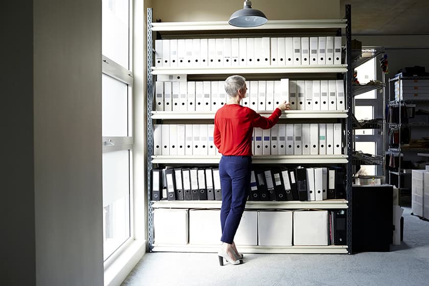 Woman in an office looking at folders