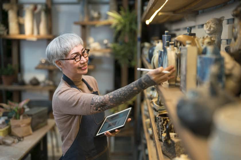 IFA_190423 Senior artist examining pottery