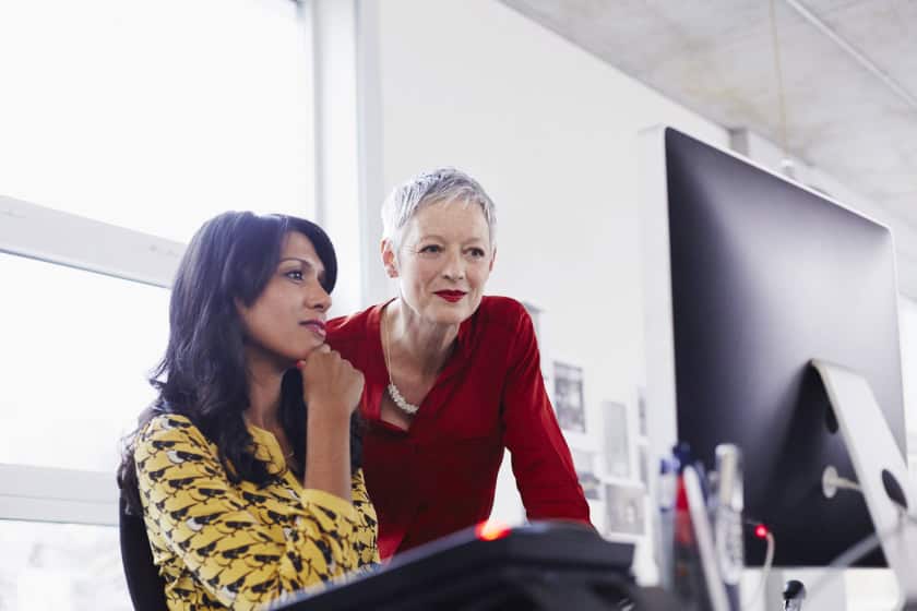 Woman_in_red_dress_looking_at_computer Women looking at computer