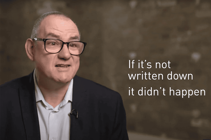aml-tim-pinkney screenshot from a video. Tim Pinkney is seated, facing the camera and speaking. Beside him the words 'If it's not written down it didn't happen' appear on screen.