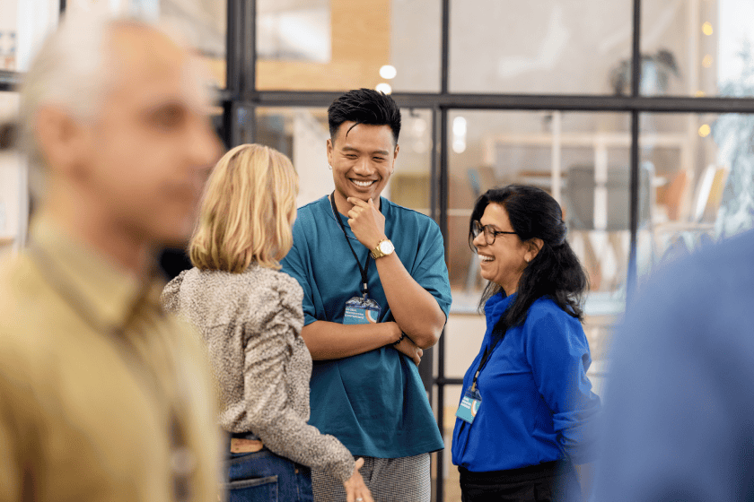 Young business people at an event. The mood of the event is jovial and cheery