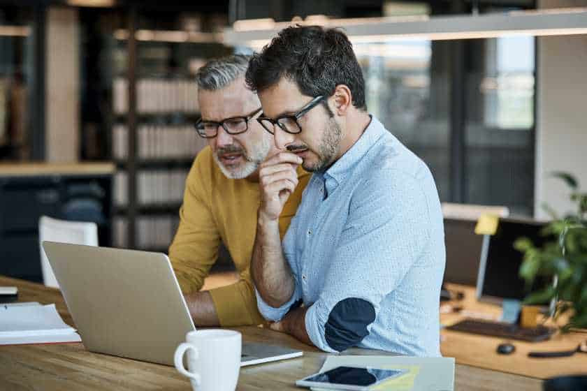 businessman_using_laptop Businessmen using laptop. The two business man are intensely engaged and focused.