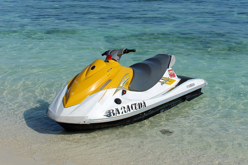 mansour-ujJlWFDPa58-unsplash A jetski parked up on a beautiful beach.