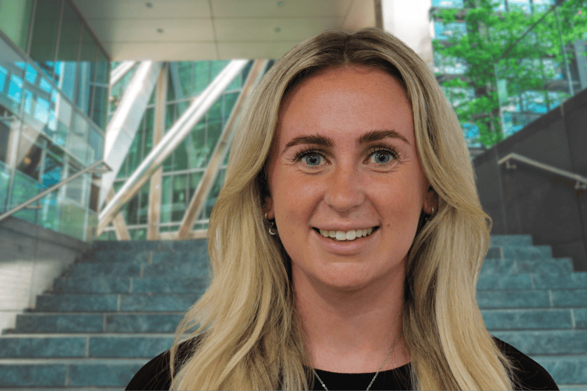 megan_leach_mattioli_woods Megan leach, Head and shoulders, in front of a commercial building