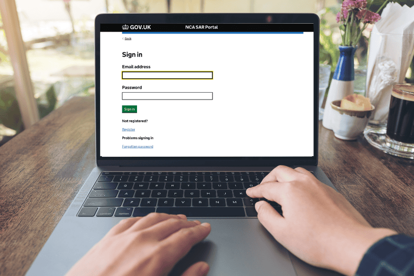 person at desk using NCA portal n laptop