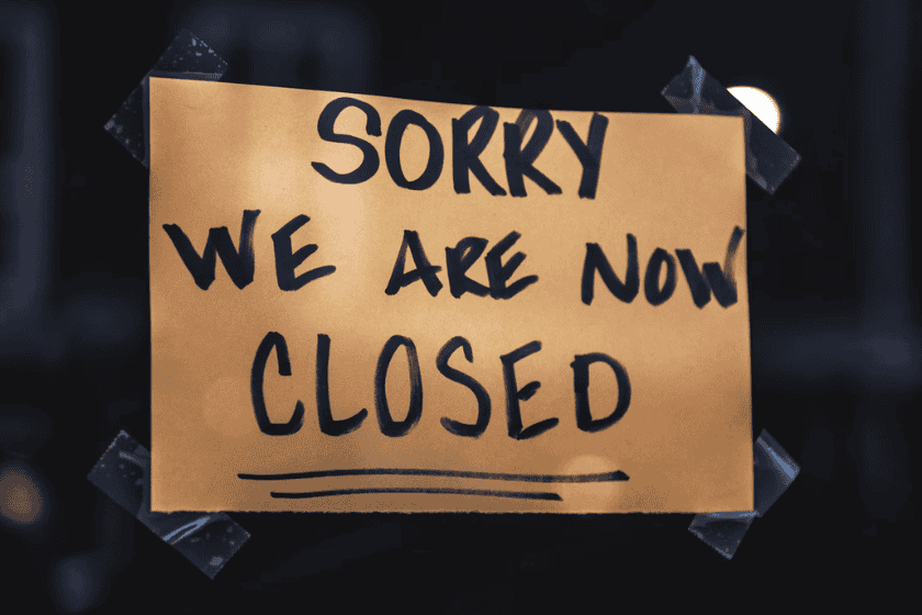 Sign taped to a window reading "Sorry we are now closed"