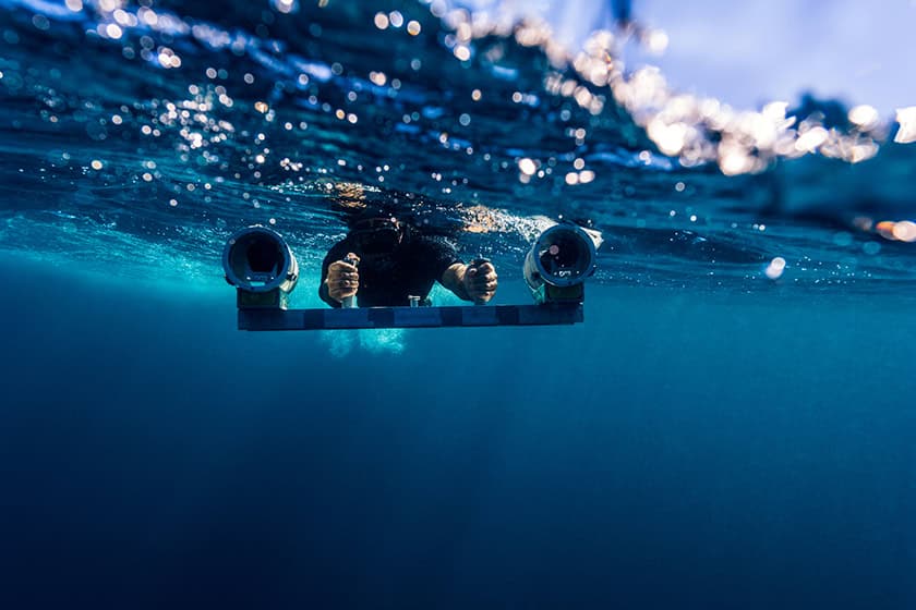 A scientist uses a stereo video camera underwater