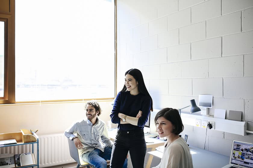 young man and women laughing in studio space