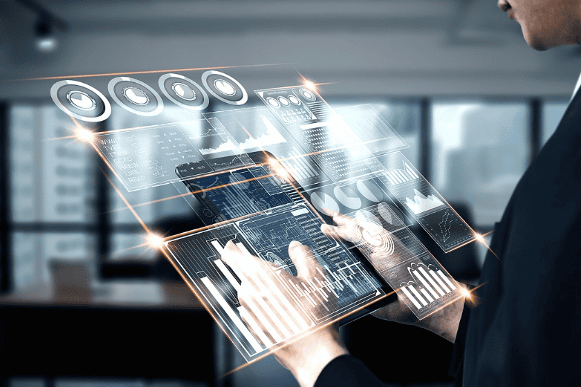 A person types on a holographic virtual dashboard in an office