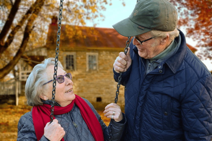 An elderly couple facing each other