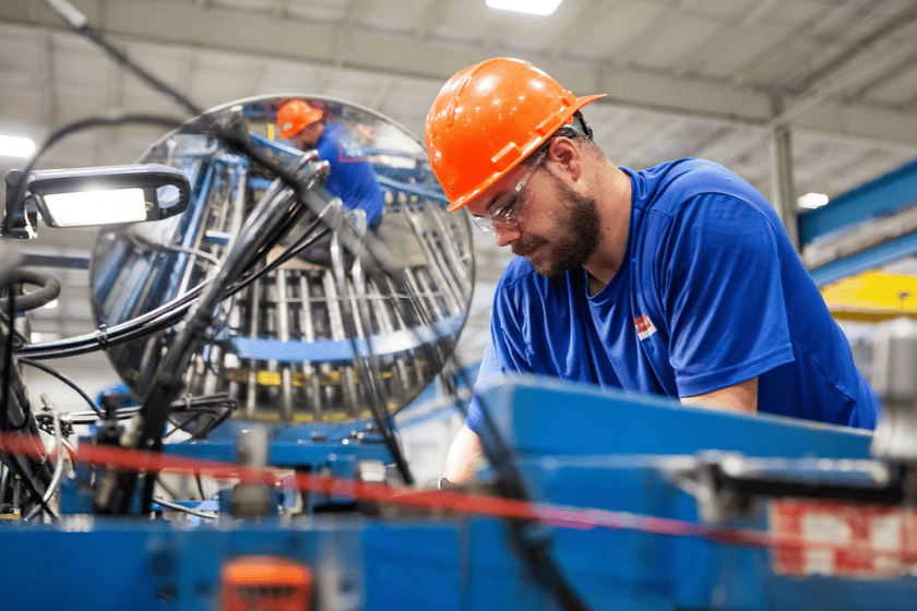 A manufacturing employee works in a factory