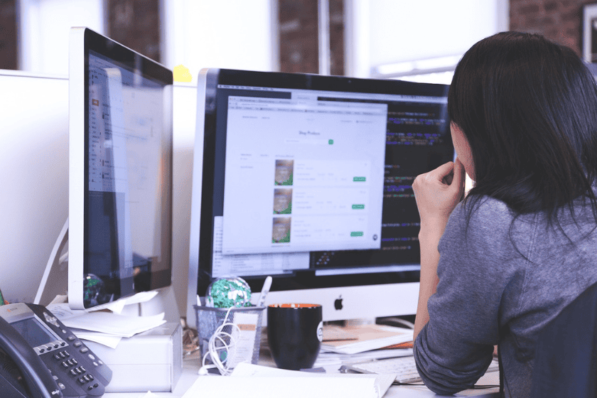 An office worker looking at their computer screen at a desk