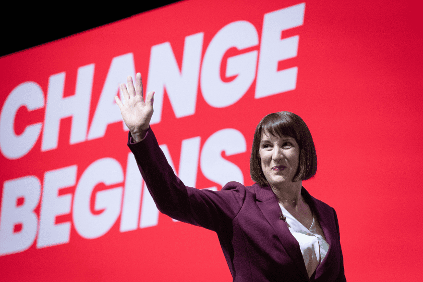uk-autumn-budget-2024-2Y9B76A Chancellor of the Exchequer Rachel Reeves raises a hand in front of a screen reading "Change begins"